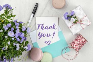 A thank you card with messages in an envelope