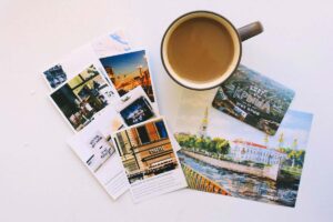 Postcards surrounding a cup of tea