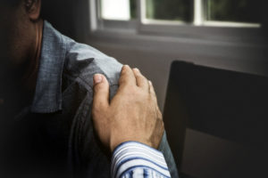Hand auf einer Schulter