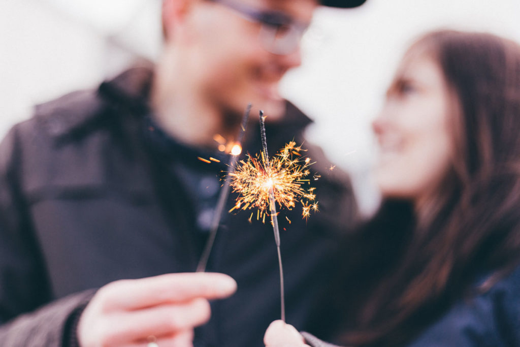 Couple holding a sparkler for New Year's Eve