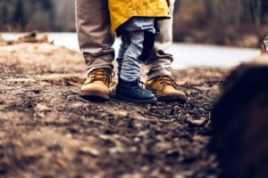 A child stands close to his parent in a half shot