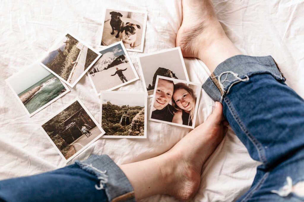 Photos on the bed between someone's legs