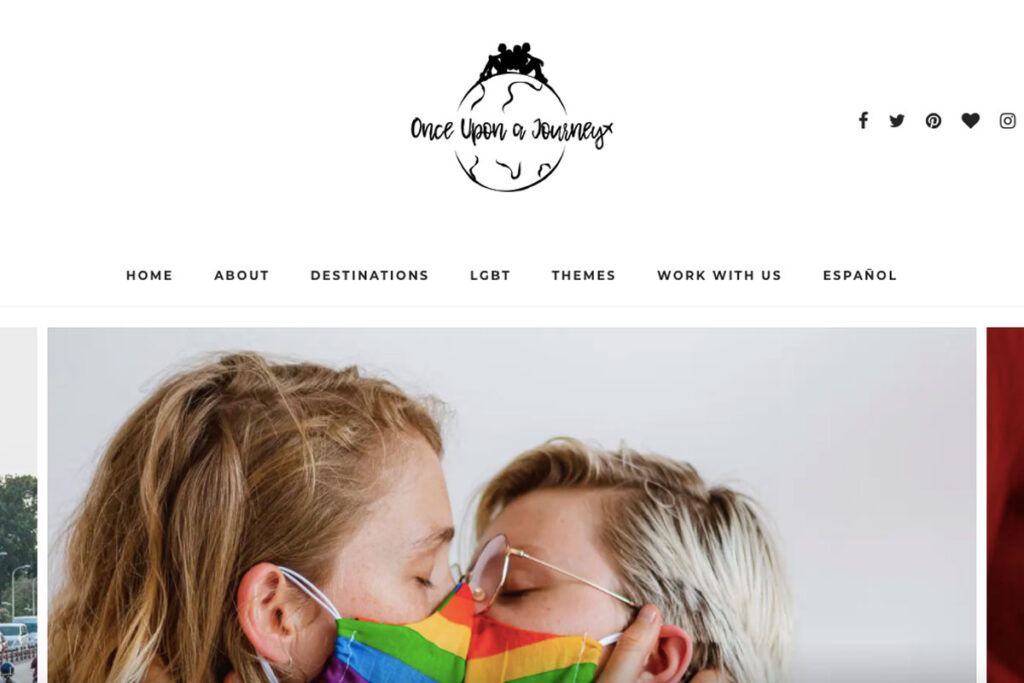 Two women kiss through rainbow masks on Once Upon A Journey homepage