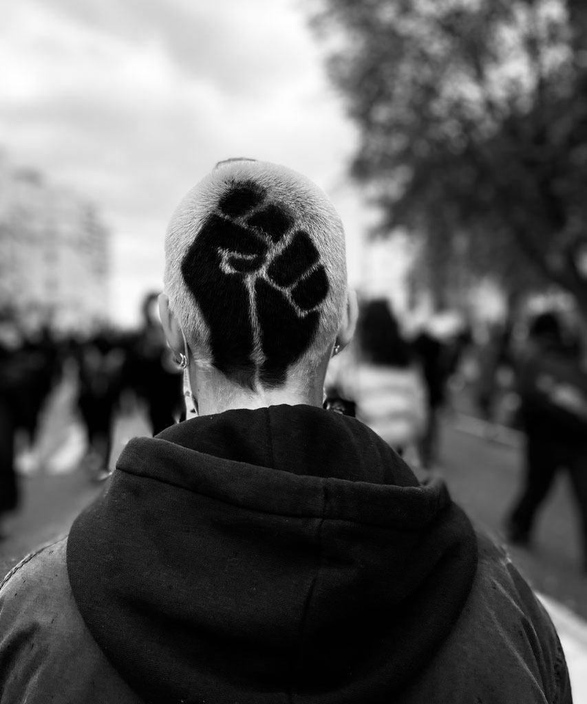 A man has the Black Power fist dyed in his hair as the new symbol of anti-racism