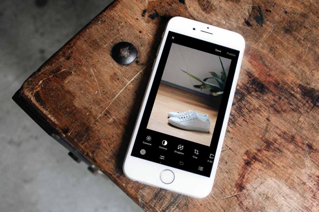 the iPhone camera app VSCO is open on the wooden table