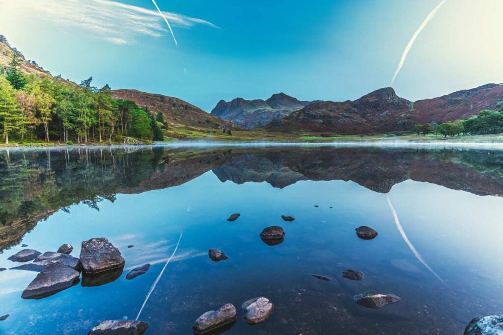 A blue lake with rocks in The Lake District is one of the best rural British landscapes to visit