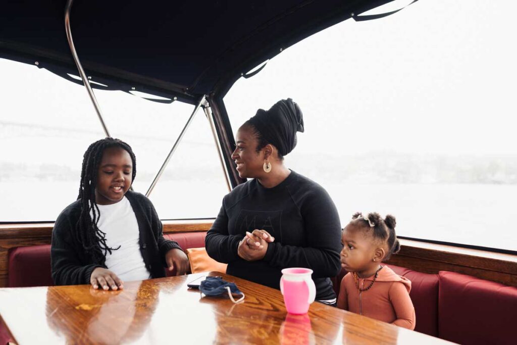 Family with kids discussing on a boat