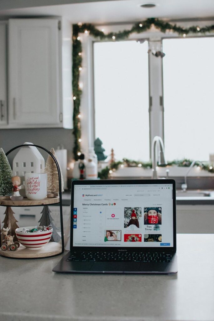 Laptop showing MyPostcard site as a way to stay connected at Christmas