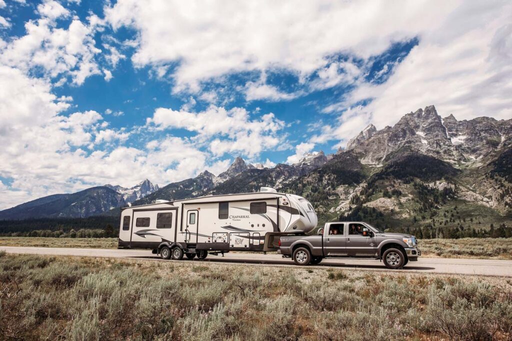 Rv and car in front of stunning scenery