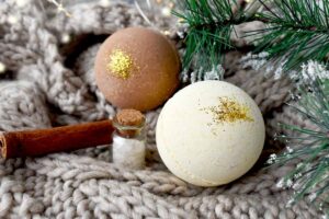 Easy homemade winter bath bombs with gold glitter under a Christmas tree