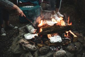 Foil-wrapped food on the fire is one of our easy camping hacks for food prep