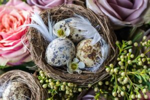 An easy DIY Easter nest craft for adults with decorated eggs lying in it