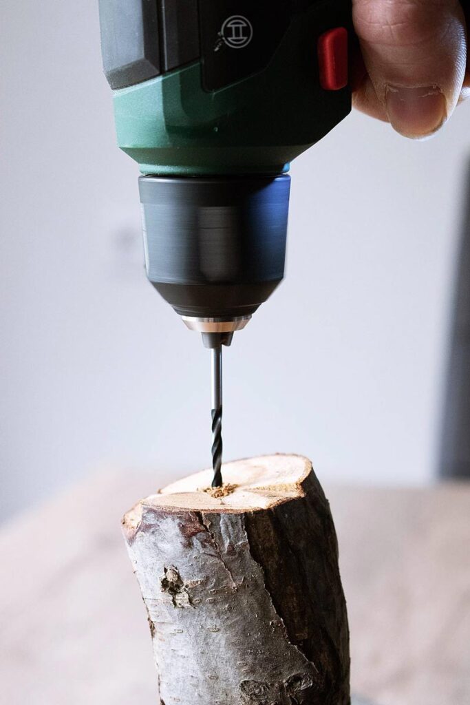 Eine Bohrmachine bohrt ein Loch in einen Stück Holz