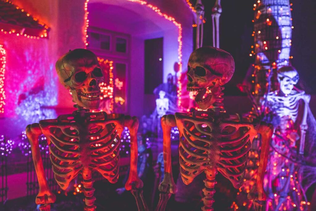 Two skeletons at a party illustrating our halloween activity ideas
