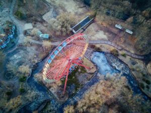 Vogelperspektive, rotes Riesenrad steht in einem verlassenen Park