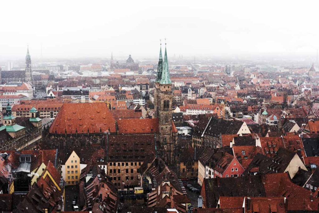 The snow falling down above the wintery city of Nuremberg in Germany