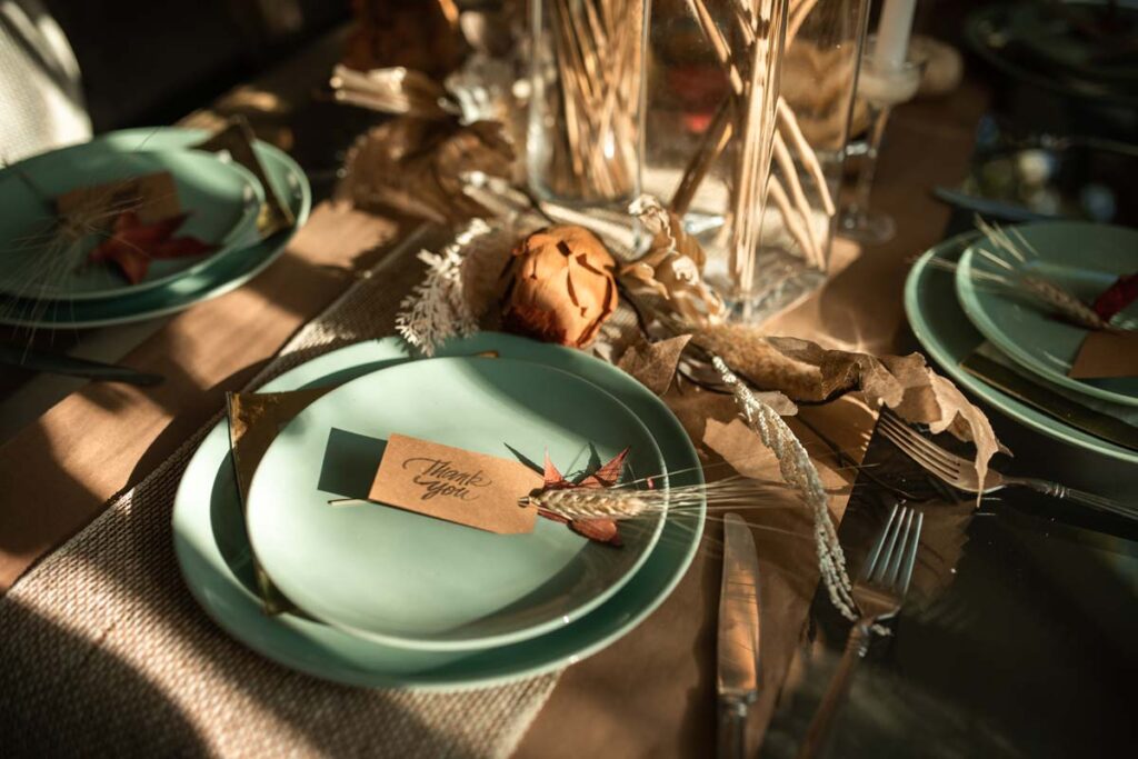 A place setting on a Thanksgiving-decorated table with DIY autumn decor for Friendsgiving