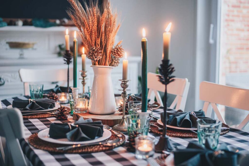 A Thanksgiving table set with fall decor ready for hosting Friendsgiving according to our tips