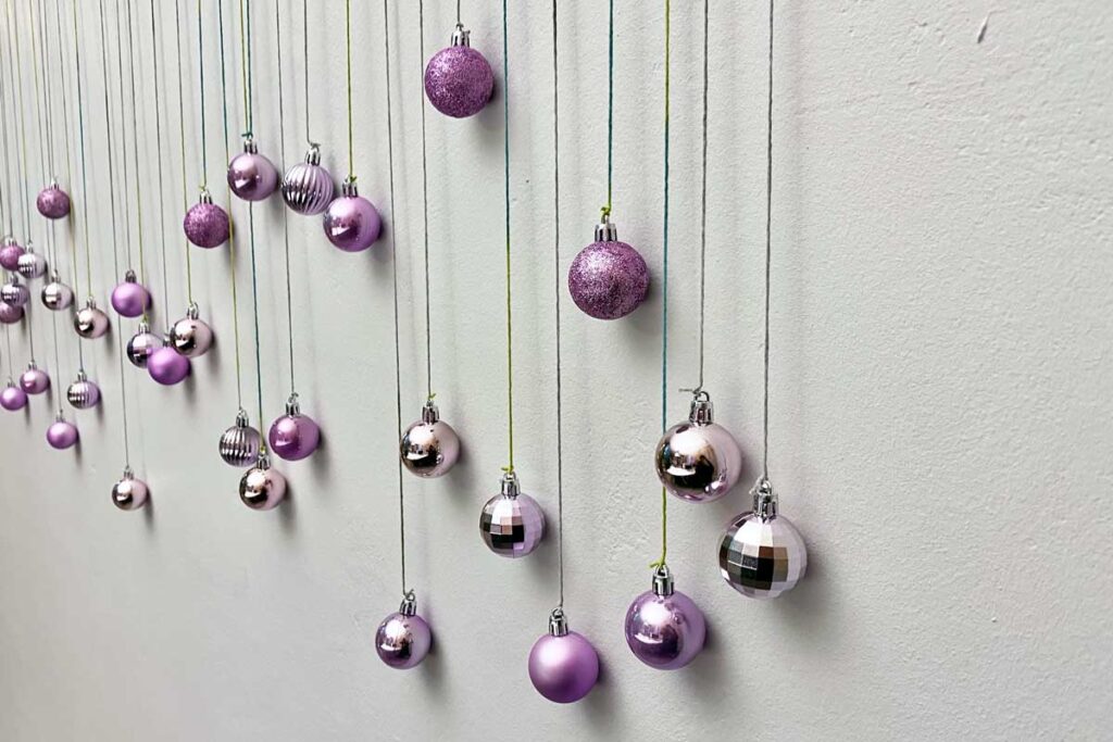 Close up of the baubles attached to string on the finished DIY Christ photo booth 