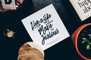A mantra typed on a square paper on the table makes for one of our great vision board ideas.
