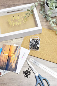 The materials needed to create an upcycled pin board key hanger as a DIY