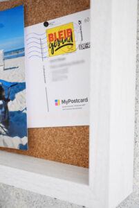 An ultra close up showing a card inside the DIY pin board
