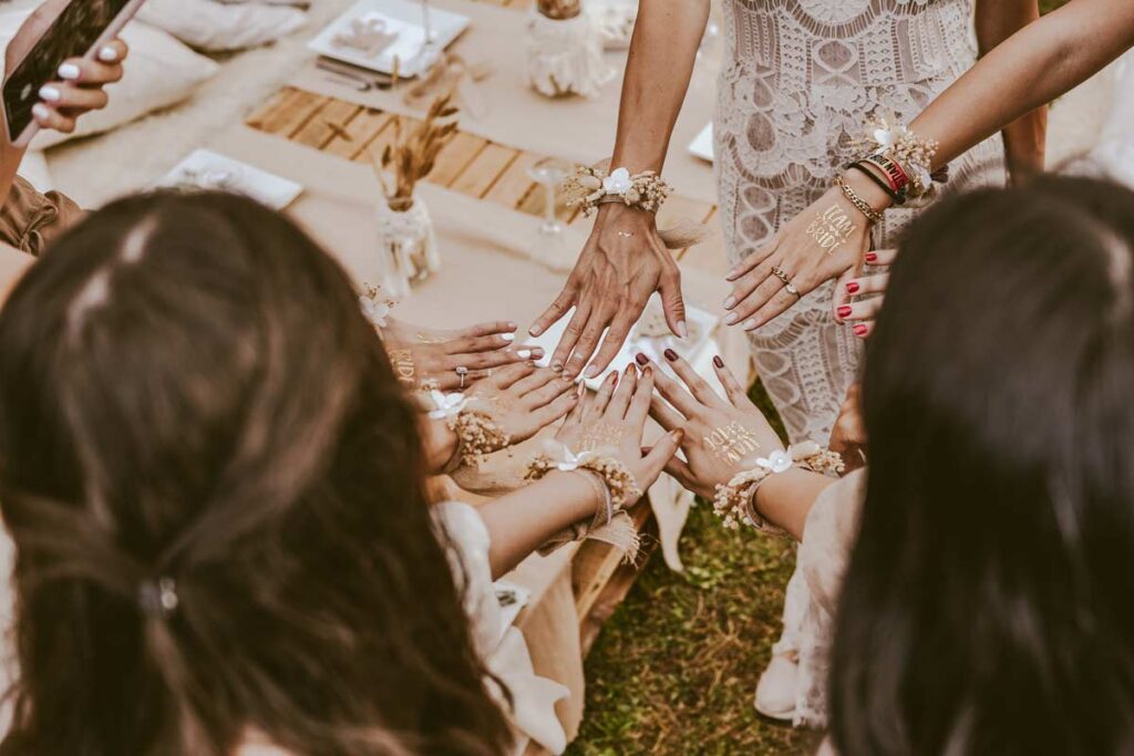 Bridesmaids at the bridal shower holding their hands together to try wedding photography tips