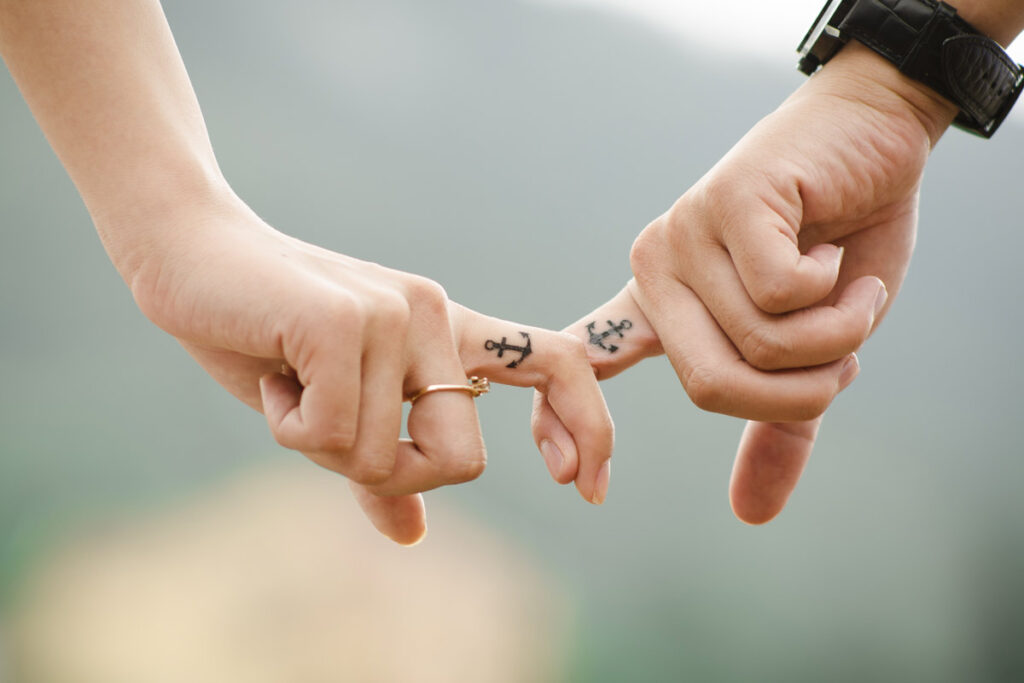 Hands touching with matching tattoos