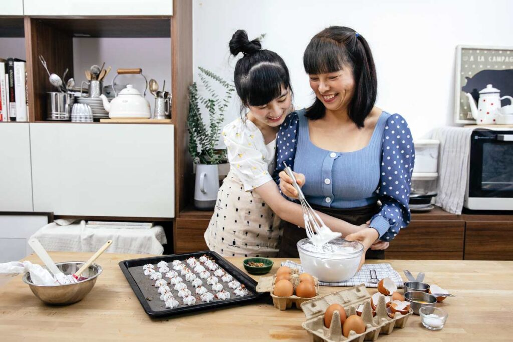 A mom and daughter bake together celebrating Mother's Day