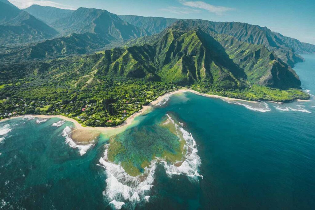 Ke'e beach in Hawaii is a beautiful view of the ocean and green peaks