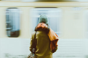 A man waiting in front of a moving train