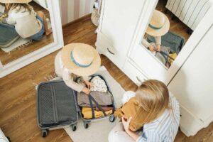A woman and girl pack for a weekend trip