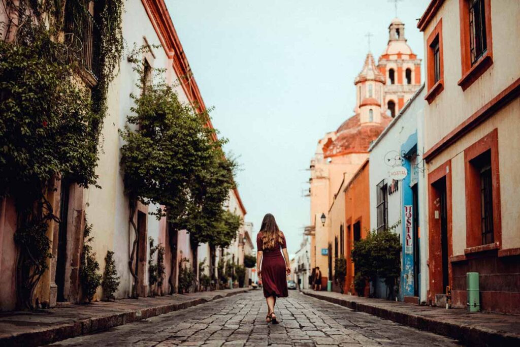 A woman walking down a city street as a tourist in her own city