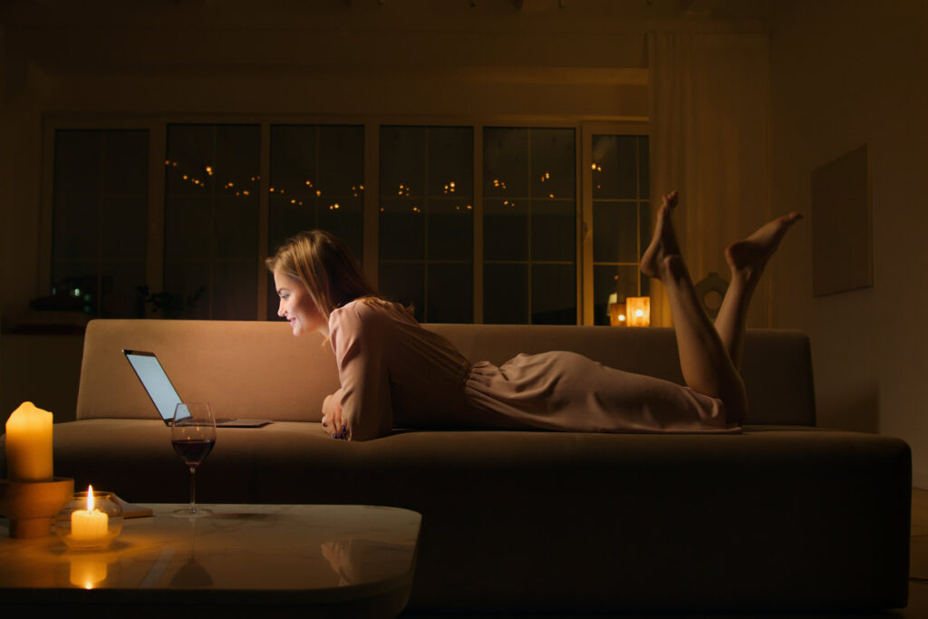 A woman doing an online call in her home in the evening
