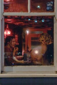 A couple sitting at the window in a restaurant on a Valentine's Day date