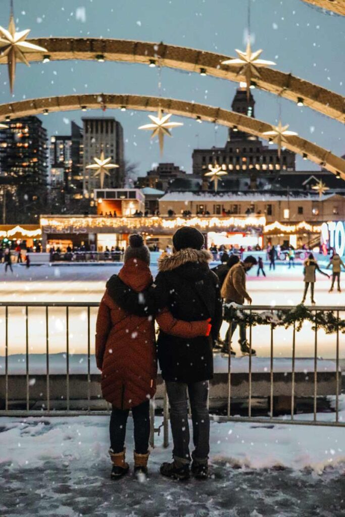 A couple looking out at a ski rink in winter