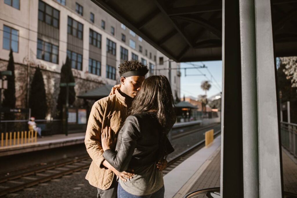 A long distance couple kiss goodbye on the train platform