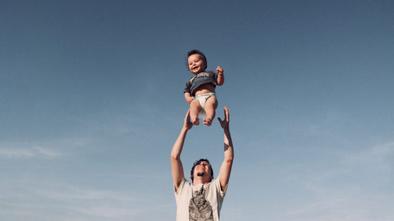 How to Write Father’s Day Messages (Or Just Copy These Quotes) A father throws his son up in the air