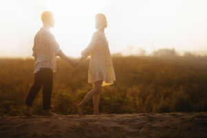 A couple hold hands while out on a walk